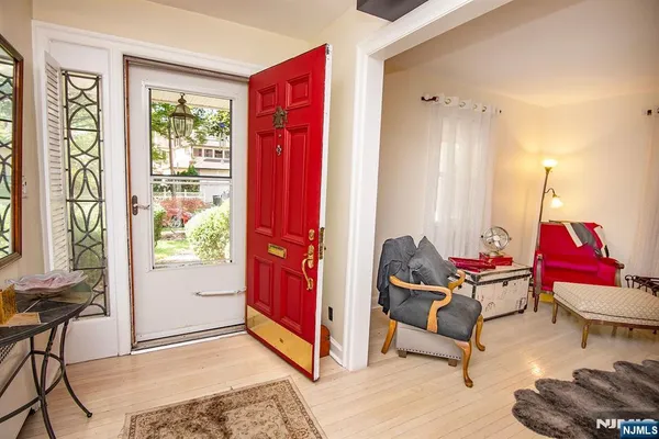 a living room with furniture and floor to ceiling windows
