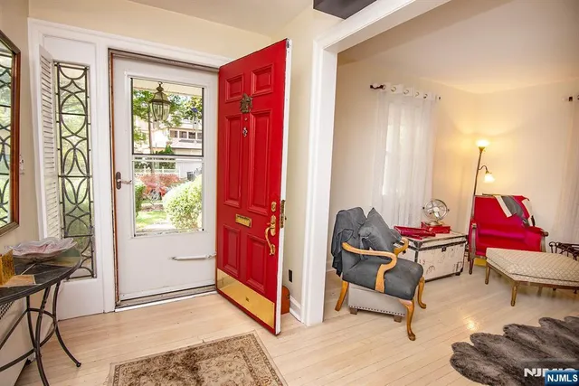 a living room with furniture and floor to ceiling windows