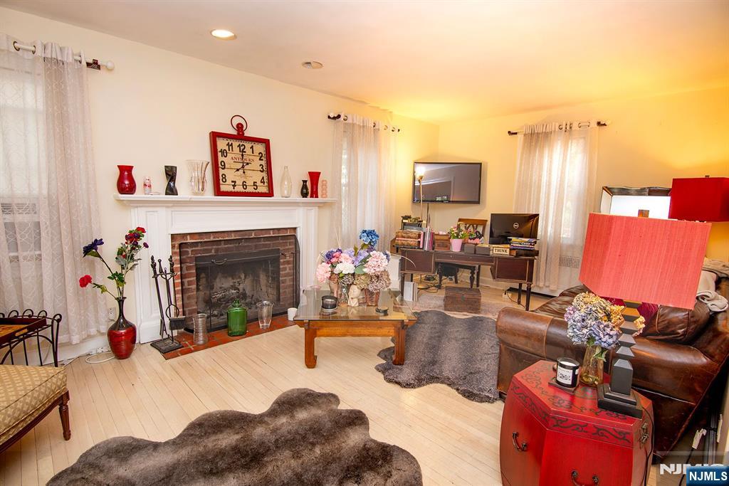 847 Red Road Teaneck, NJ 07666 - Photo 4 of 20 a living room with furniture and a fireplace