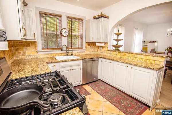 a kitchen with a sink stove and cabinets