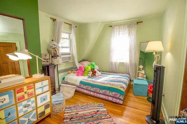 a bedroom with a bed dresser and a window