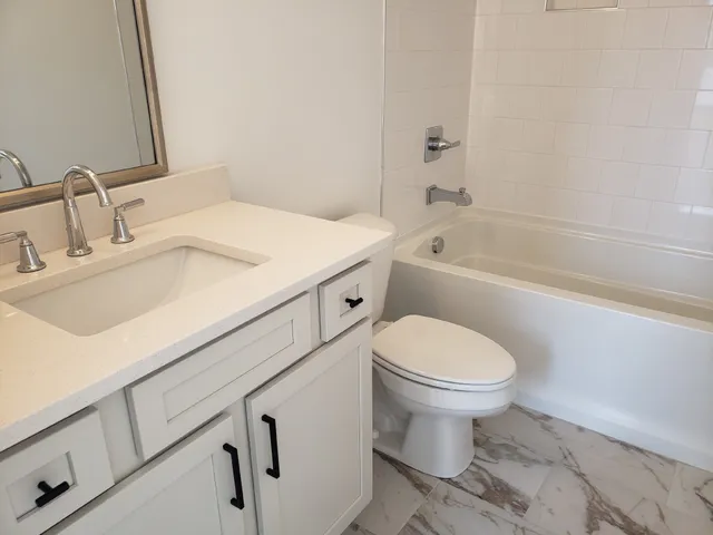 a bathroom with a sink toilet and bathtub