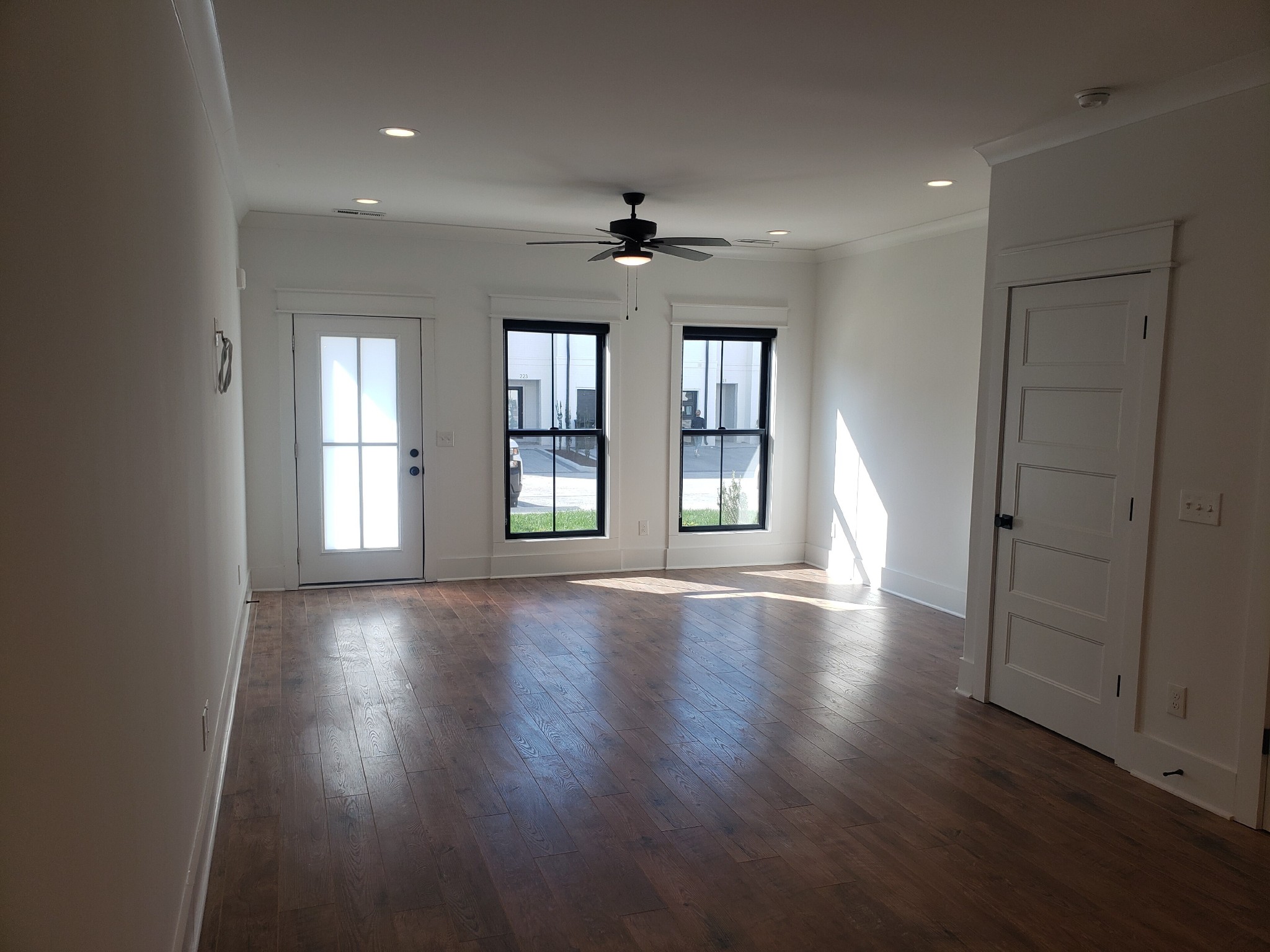 213 Mcauliffe Street Murfreesboro, TN 37130 - Photo 2 of 12 an empty room with wooden floor chandelier and windows
