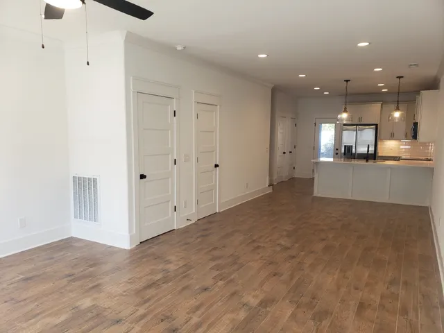 a view of a big room with chandelier and windows