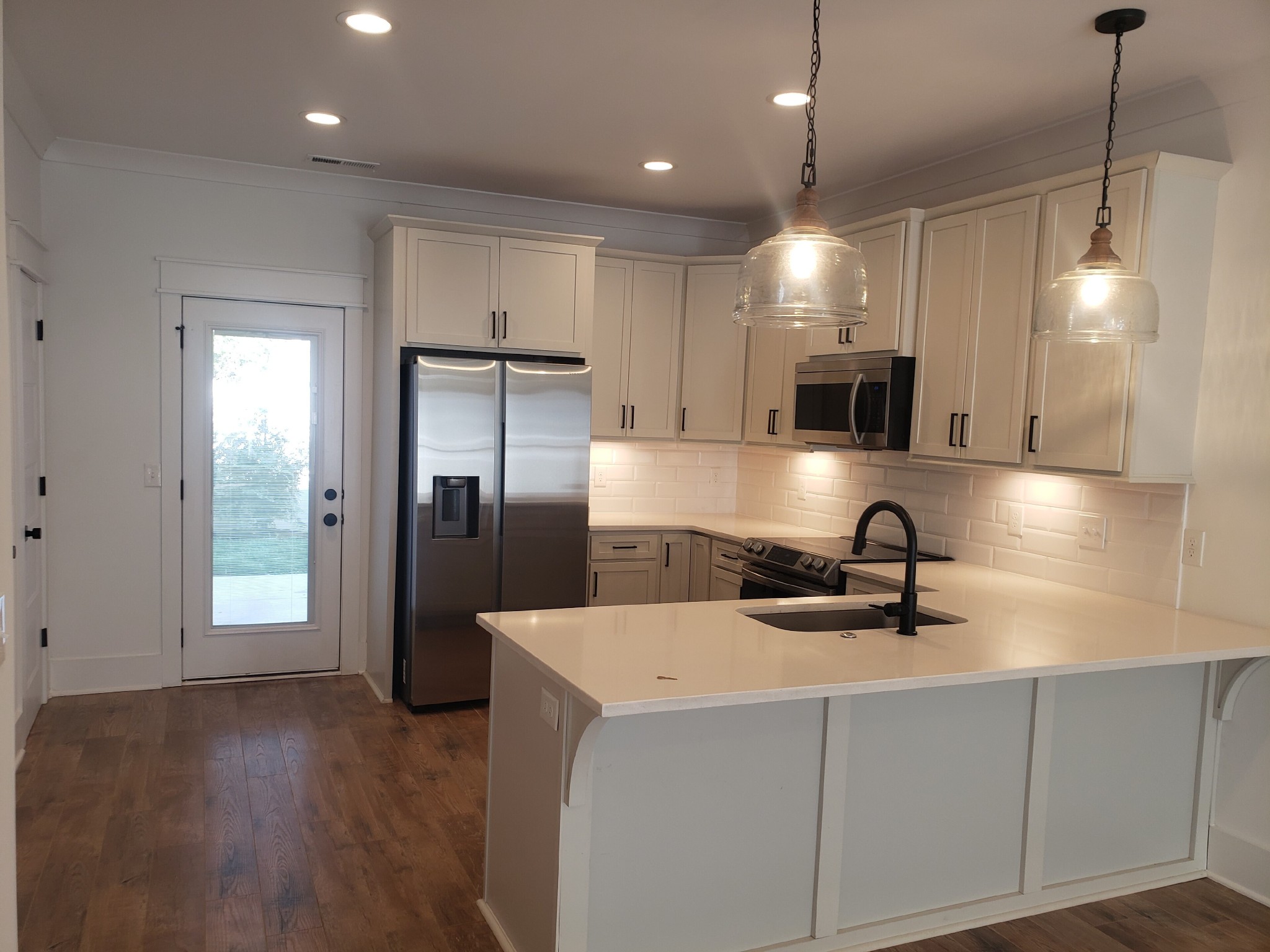213 Mcauliffe Street Murfreesboro, TN 37130 - Photo 4 of 12 a kitchen with kitchen island a sink stainless steel appliances and cabinets