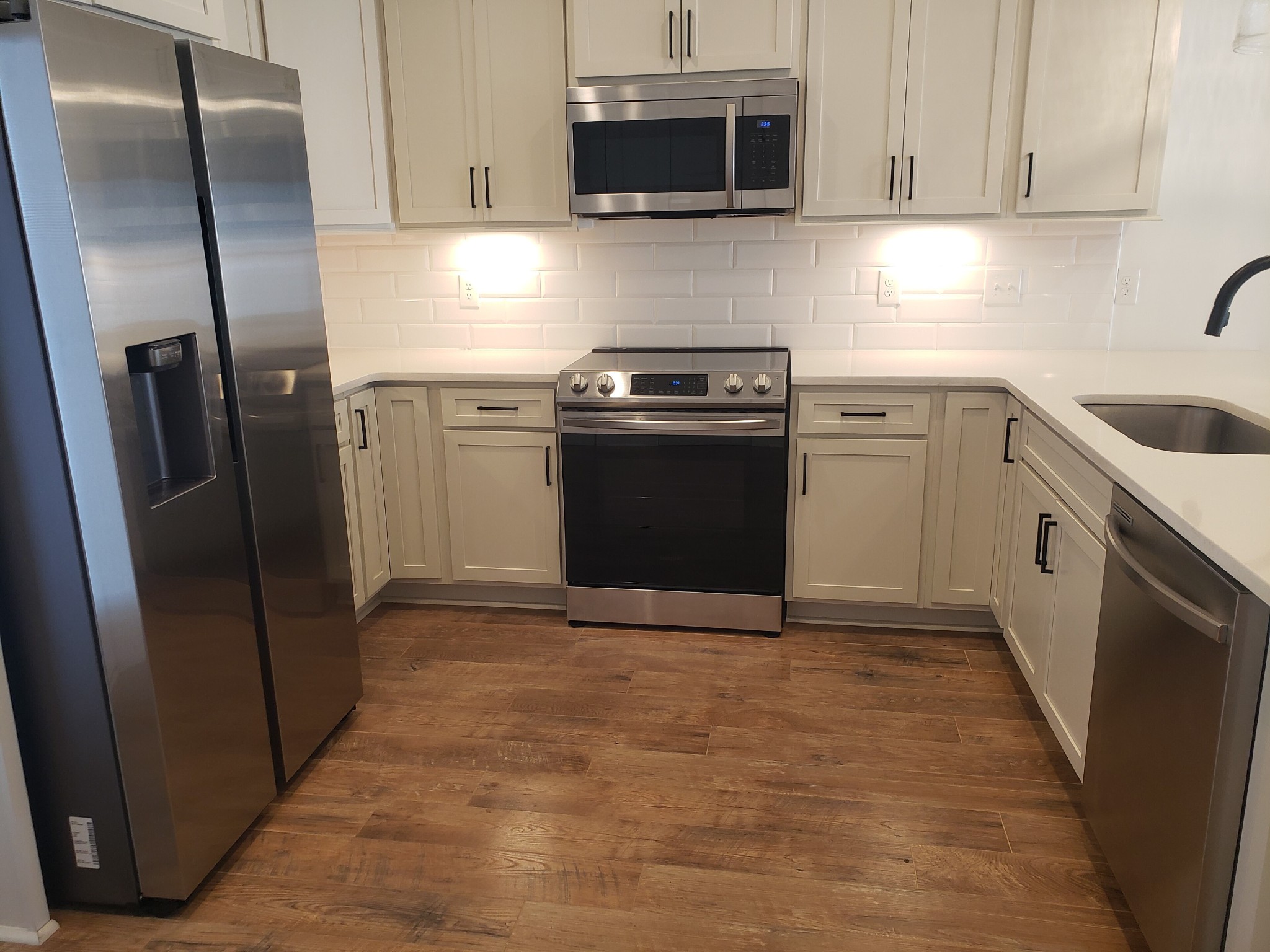 213 Mcauliffe Street Murfreesboro, TN 37130 - Photo 5 of 12 a kitchen with stainless steel appliances granite countertop a refrigerator a stove a sink and white cabinets