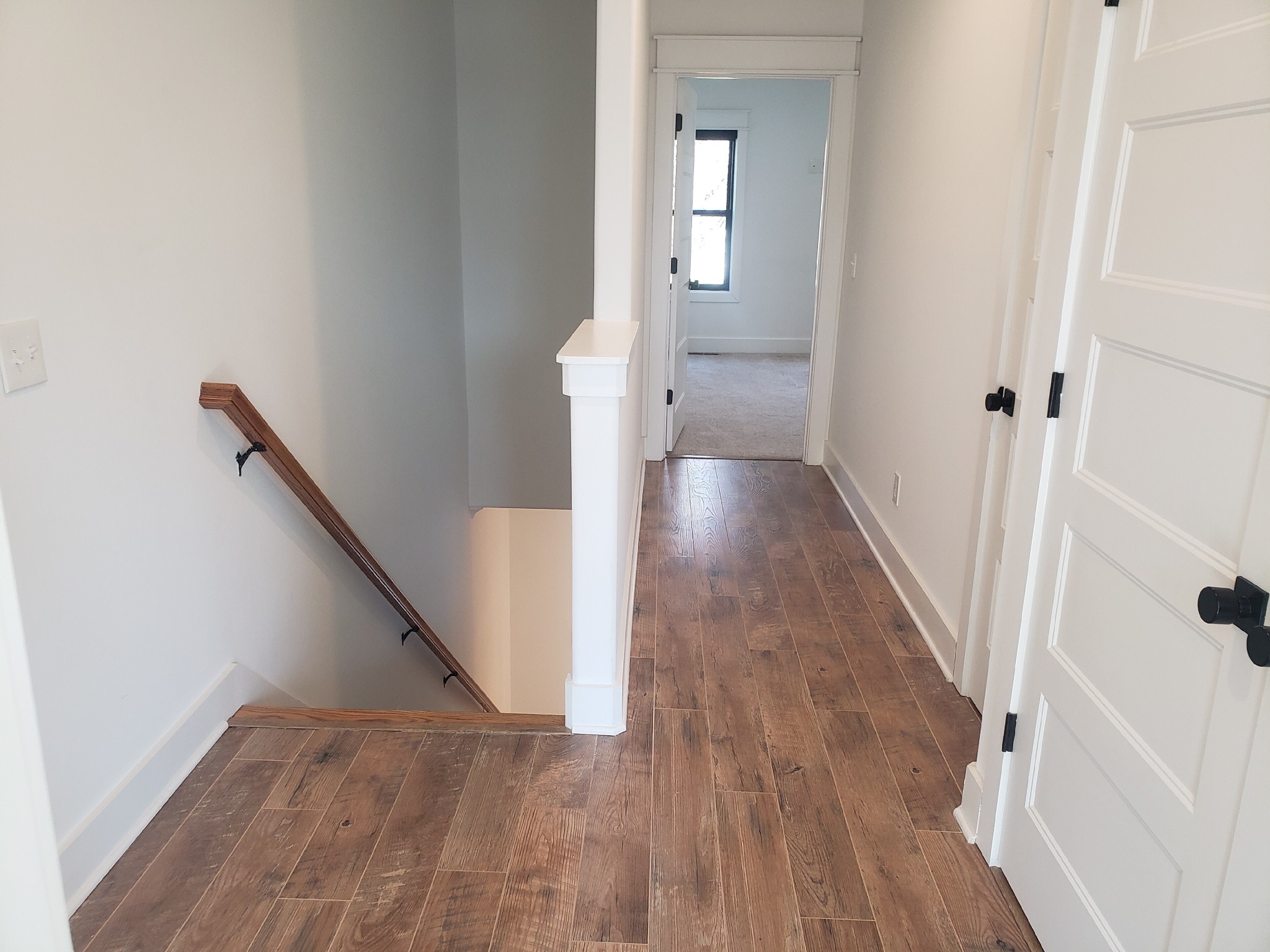 213 Mcauliffe Street Murfreesboro, TN 37130 - Photo 6 of 12 a view of a hallway with wooden floor and staircase