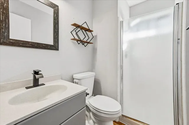 a white toilet sitting next to a bathroom sink
