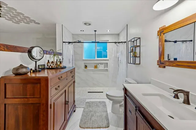 a bathroom with a sink a vanity and a mirror