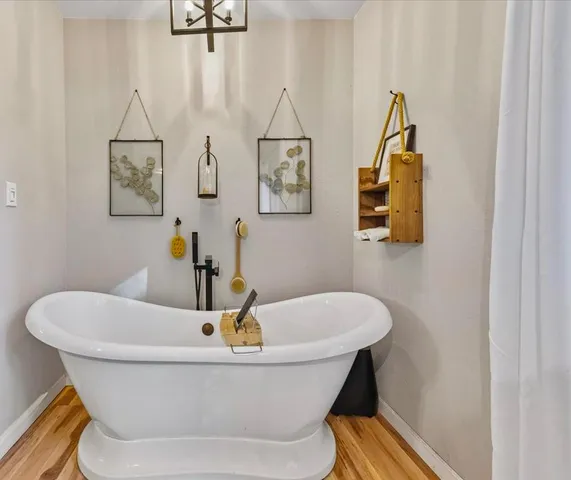 a white bath tub sitting next to a white sink