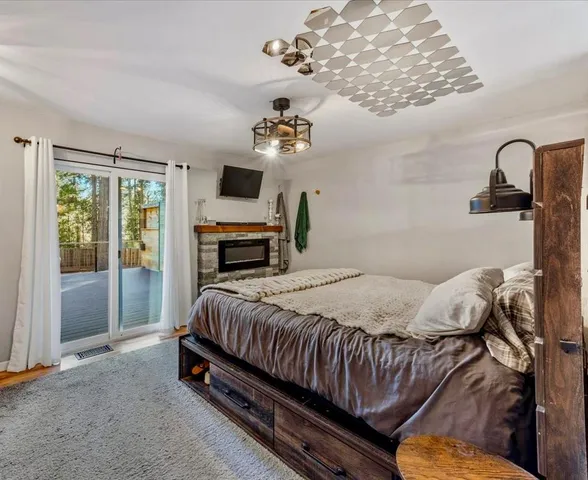 a bedroom with a bed wooden floor and window