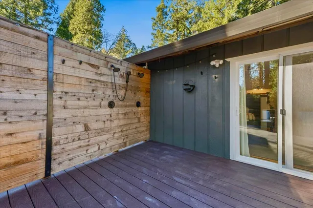 a view of a deck with table and chairs with wooden floor and fence