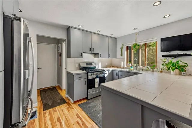 a kitchen with a refrigerator and a sink