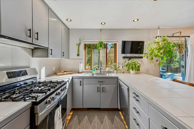 a kitchen with a stove a sink and a refrigerator