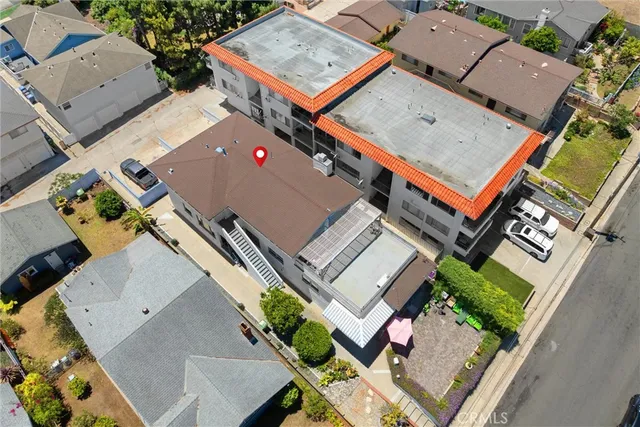 an aerial view of a house with a yard