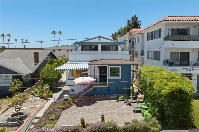 a aerial view of a house with a yard and sitting area