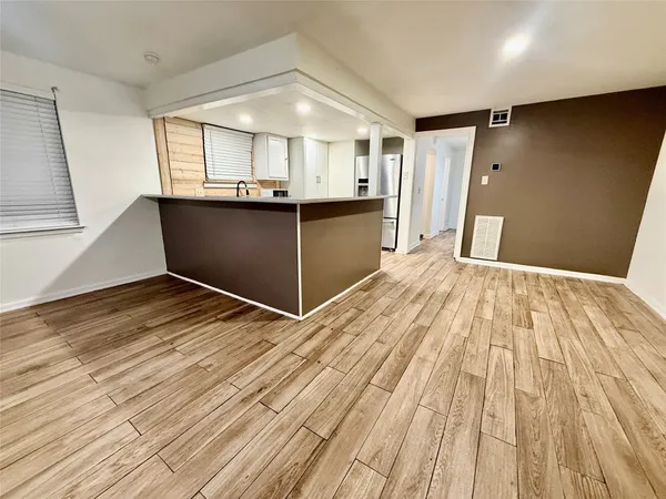 a view of a room with wooden floor and staircase