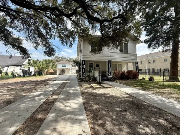 a front view of a building with trees