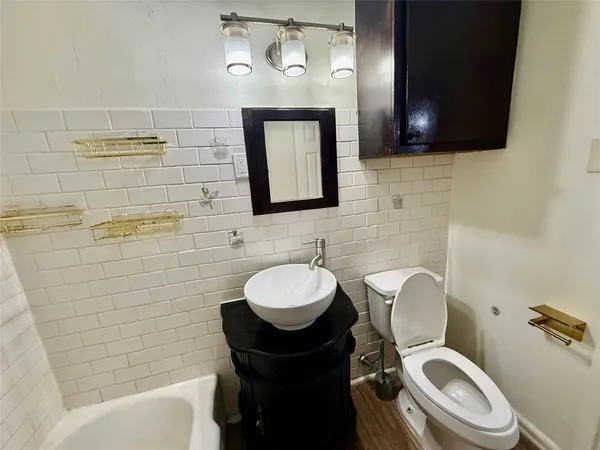 a bathroom with a toilet a sink and bathtub