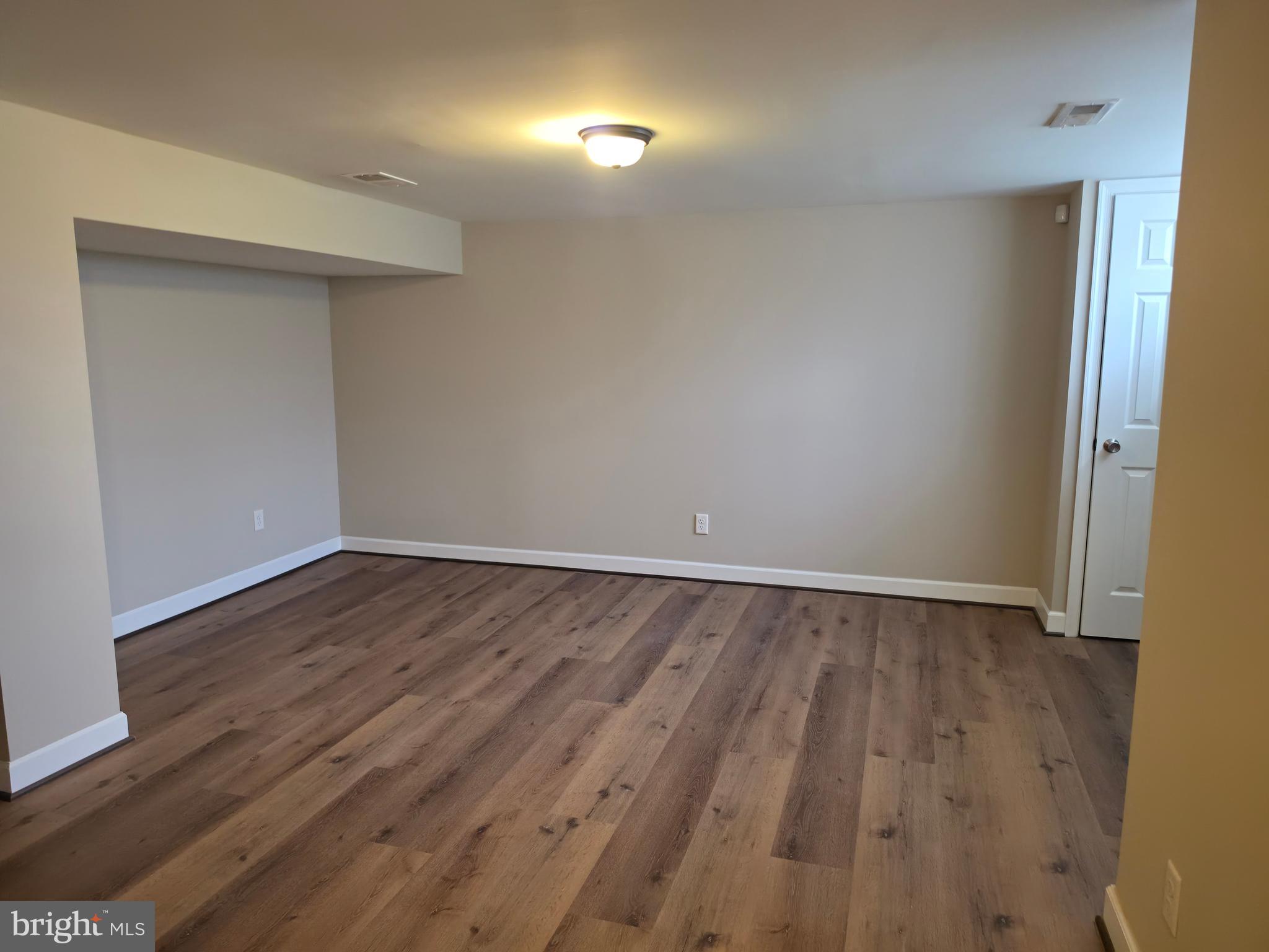 2028 Hillenwood Road Baltimore, MD 21239 - Photo 14 of 18 a view of an empty room with wooden floor