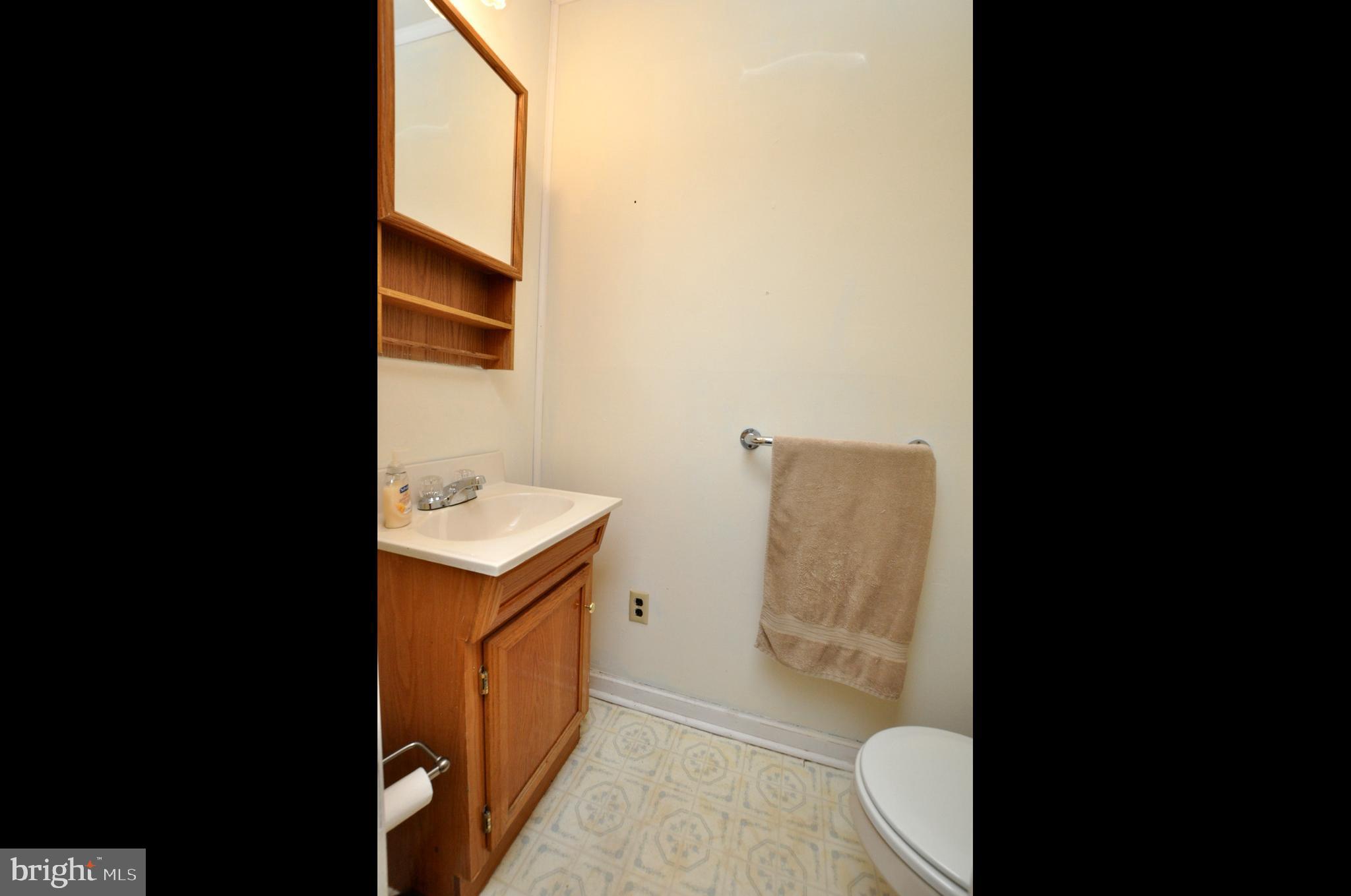 607 North Broad Street Hainesport, NJ 08036 - Photo 12 of 24 a bathroom with a granite countertop toilet and a sink