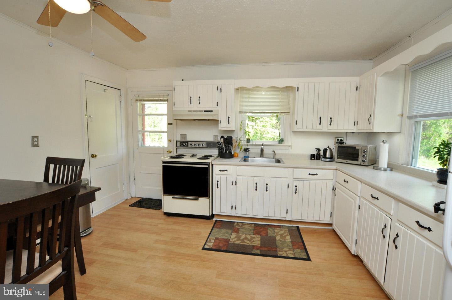 607 North Broad Street Hainesport, NJ 08036 - Photo 4 of 24 a kitchen with stainless steel appliances granite countertop a stove a sink dishwasher and a refrigerator with wooden floor