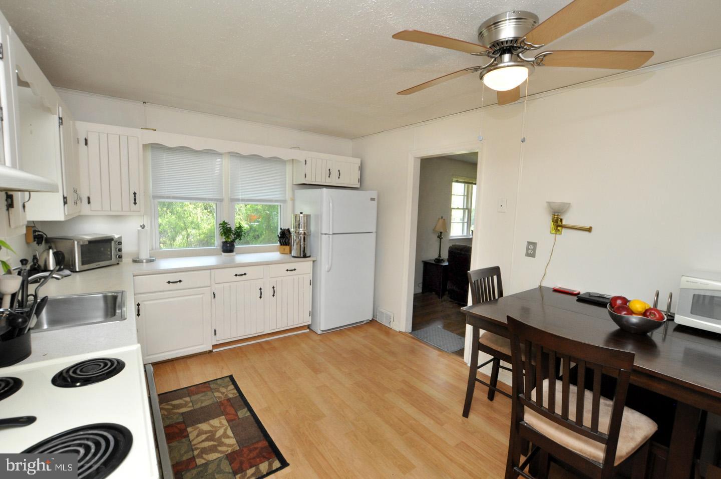 607 North Broad Street Hainesport, NJ 08036 - Photo 5 of 24 a kitchen with a table chairs a stove a dining table and chairs
