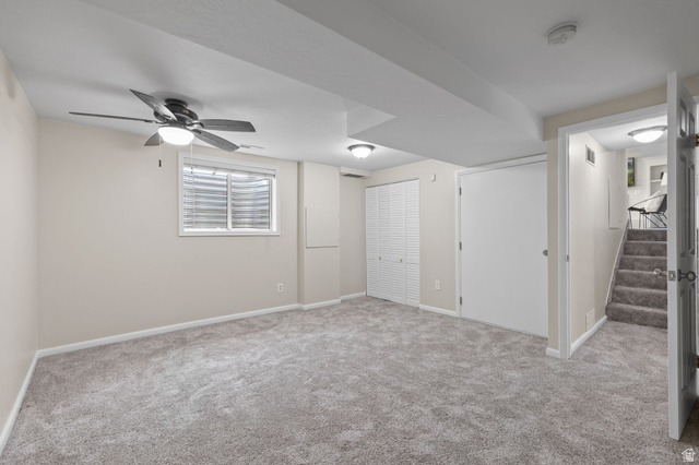 2370 Quail Run Circle East Sandy, UT 84093 - Photo 30 of 54 Spacious room featuring neutral carpet, a ceiling fan with integrated lighting, recessed lighting, and a window with blinds.