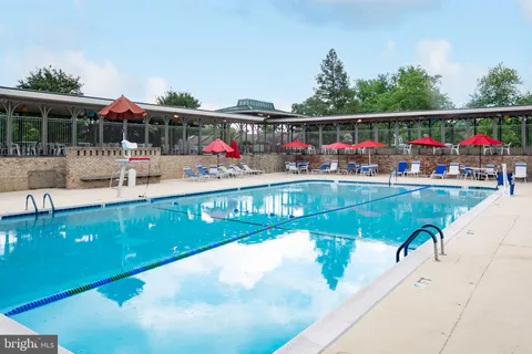 a view of swimming pool with sitting area