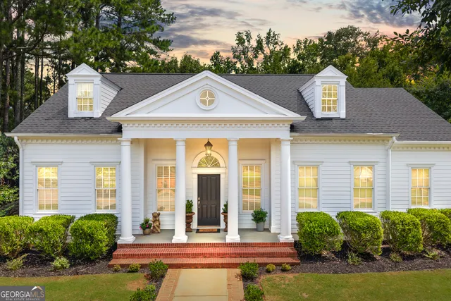 a front view of a house with garden