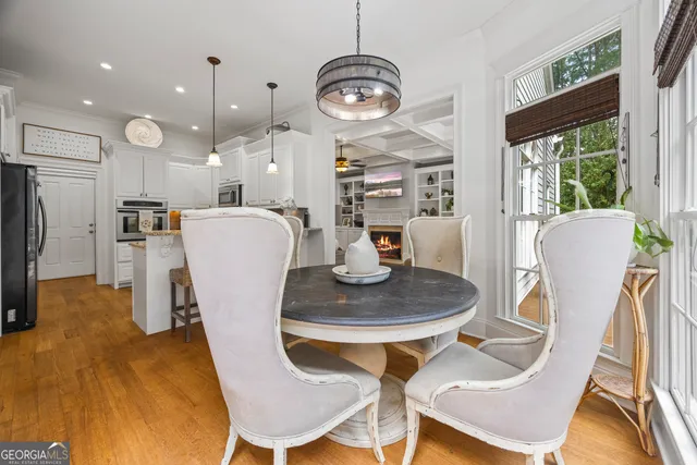 a bathroom with a granite countertop double vanity sink a mirror a vanity and a bathtub