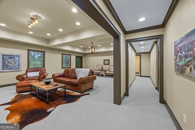 a living room with furniture and a floor to ceiling window