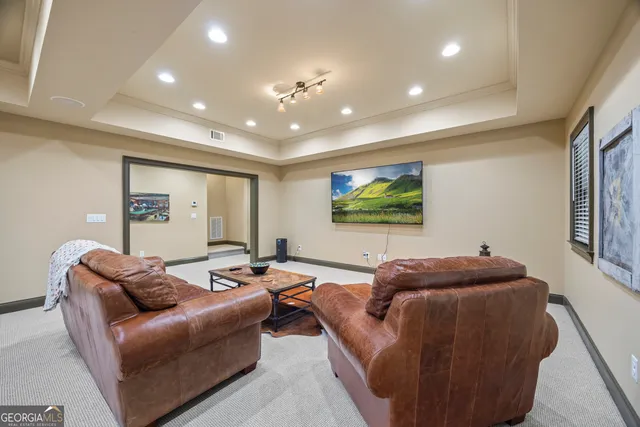 a view of a house with a yard and large tree