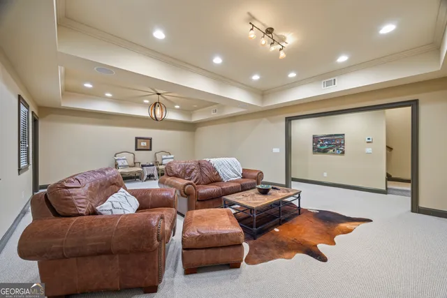 a view of a house with large windows and a tree