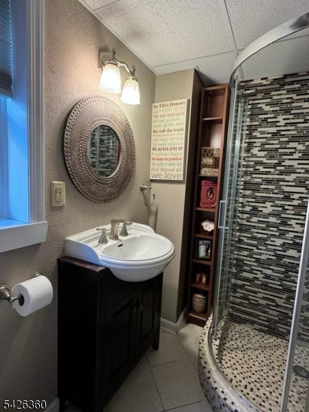 2837 Myrtle Terrace Linden, NJ 07036 - Photo 11 of 15 a bathroom with a sink a mirror and shower