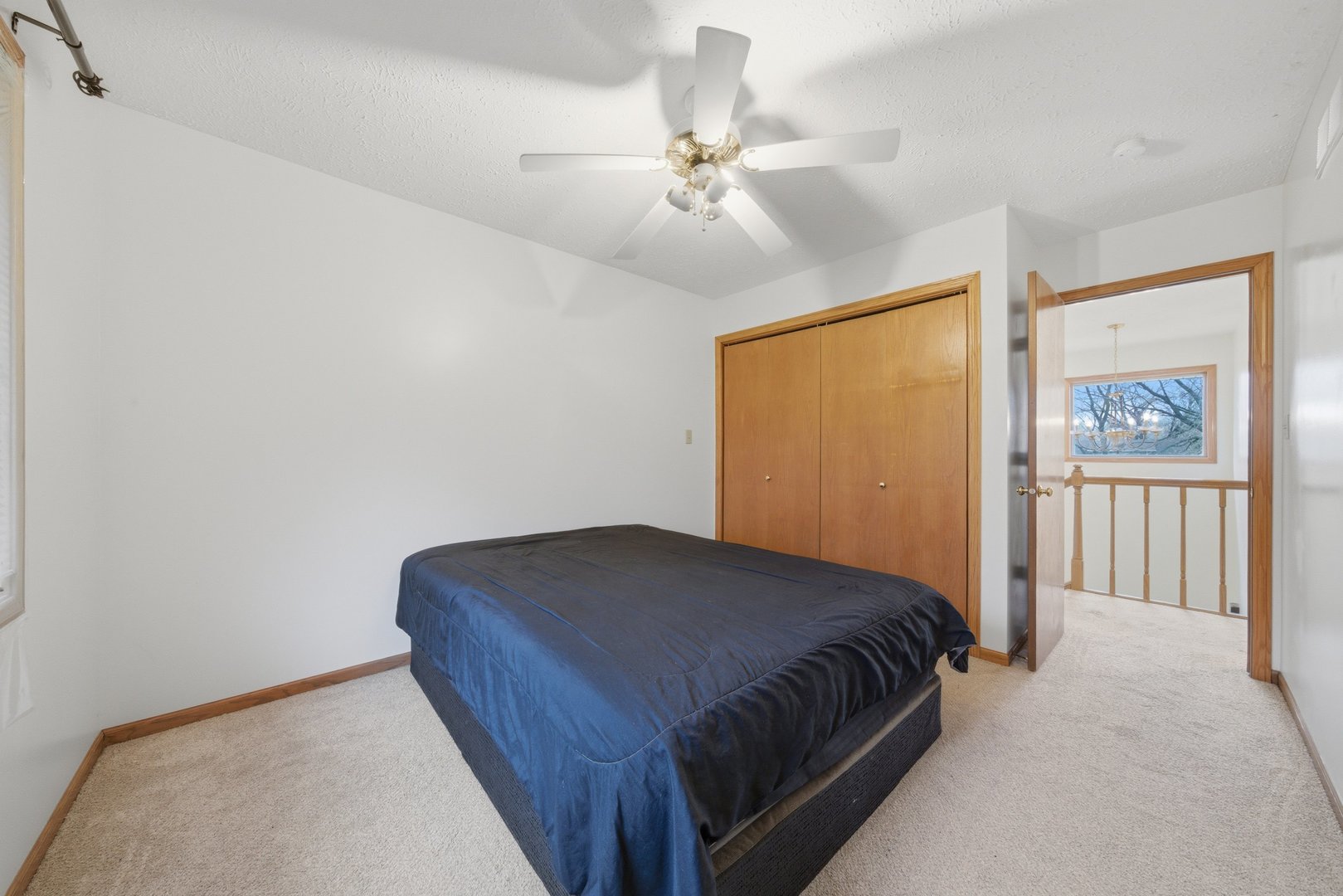 1016 North 7th Street Rochelle, IL 61068 - Photo 16 of 39 a bedroom with a bed and a chandelier