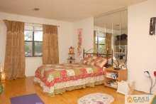1425 Raspberry Court Edison, NJ 08817 - Photo 2 of 8 a bed sitting in a spacious bedroom next to a window