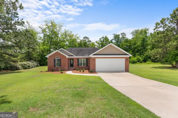 a front view of a house with yard