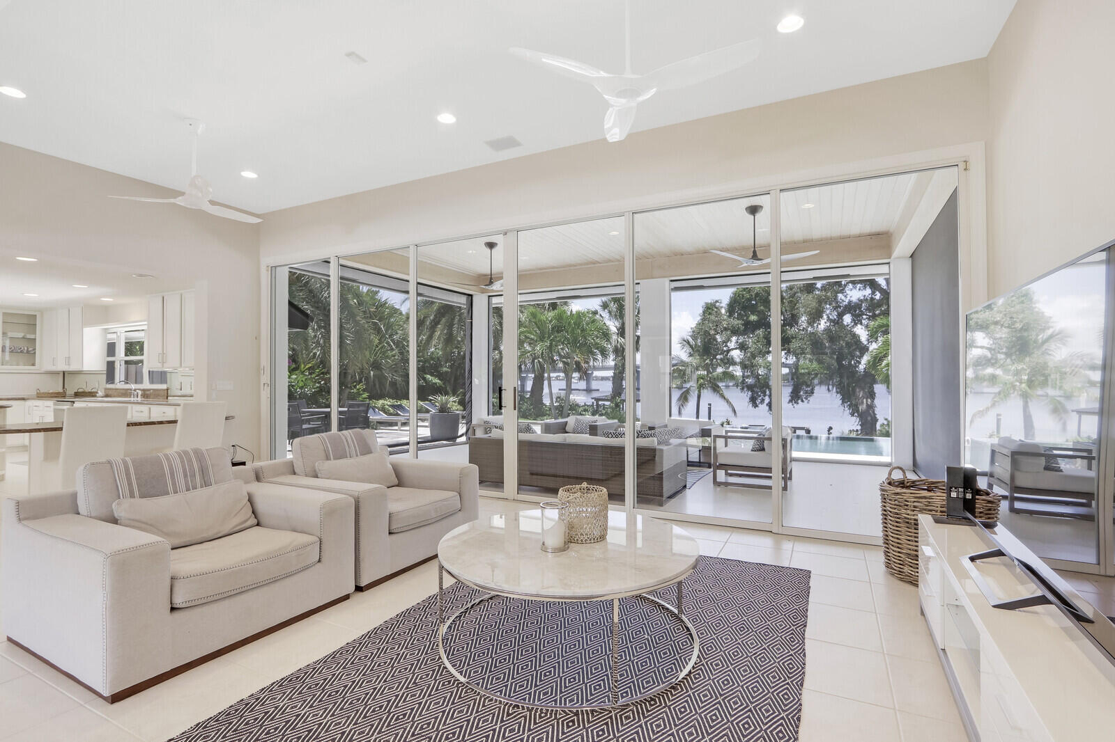 11 North River Road Sewall's Point, FL 34996 - Photo 20 of 67 a living room with furniture large windows and wooden floor