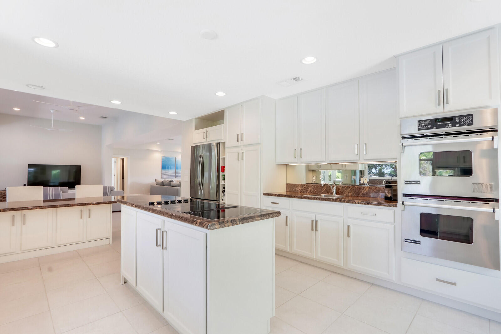 11 North River Road Sewall's Point, FL 34996 - Photo 28 of 67 a kitchen with stainless steel appliances a stove sink and microwave