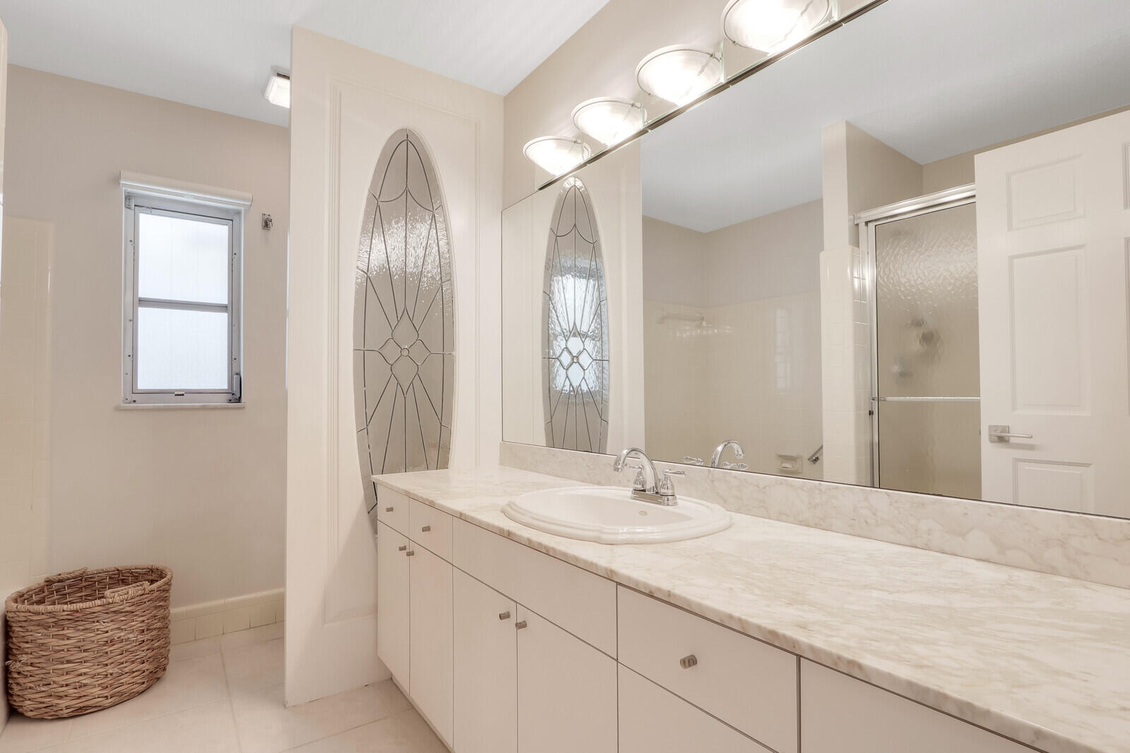 11 North River Road Sewall's Point, FL 34996 - Photo 30 of 67 a bathroom with a double vanity sink and a mirror