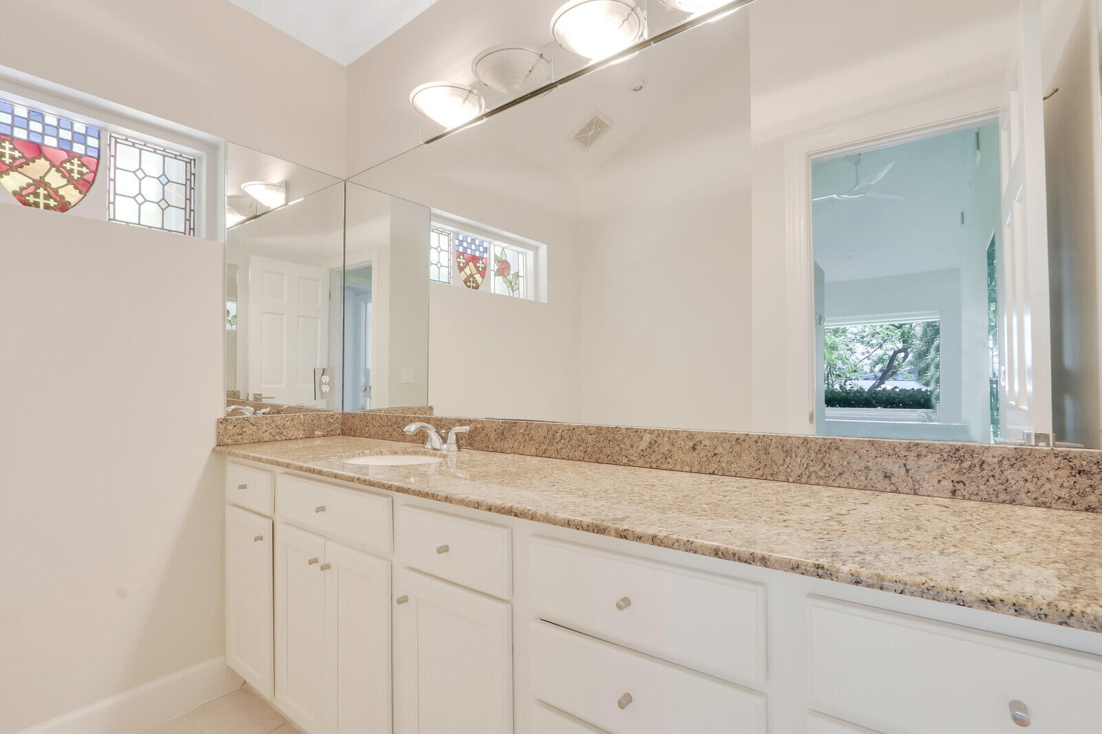 11 North River Road Sewall's Point, FL 34996 - Photo 38 of 67 a bathroom with a granite countertop sink and a mirror