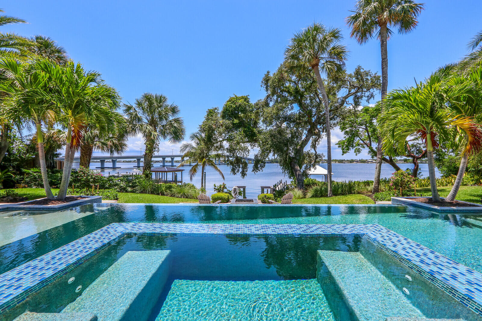 11 North River Road Sewall's Point, FL 34996 - Photo 53 of 67 a view of a swimming pool with a garden and plants