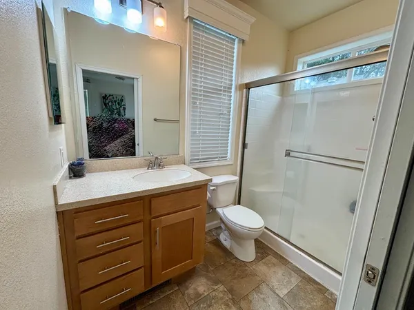 a bathroom with a sink toilet and shower