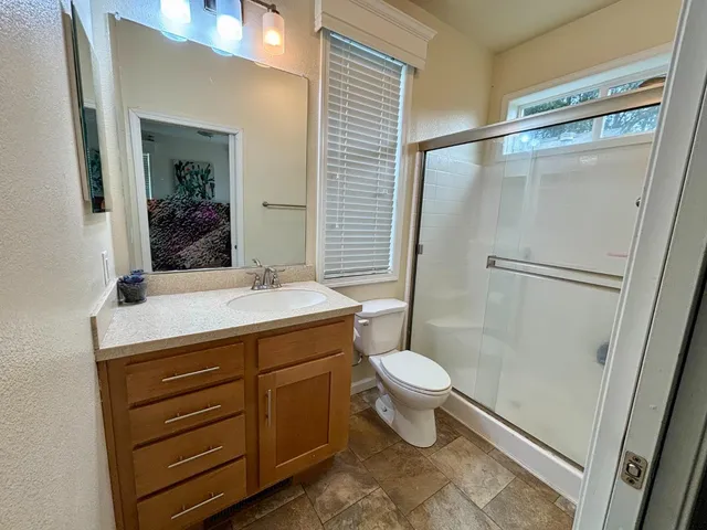 a bathroom with a sink toilet and shower