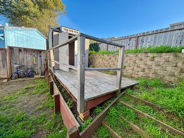 a view of a backyard with wooden fence