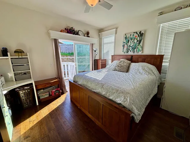 a bedroom with a bed and a flat tv screen on the dresser