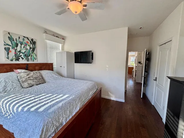 a bedroom with a bed and a flat screen tv