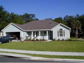 6434 Southwest 84 Terrace Gainesville, FL 32608 - Photo 1 of 1 a front view of a house with a yard