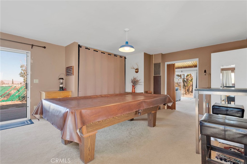 9482 Palomar Trail Lucerne Valley, CA 92356 - Photo 12 of 45 a spacious bedroom with a bed and a chandelier